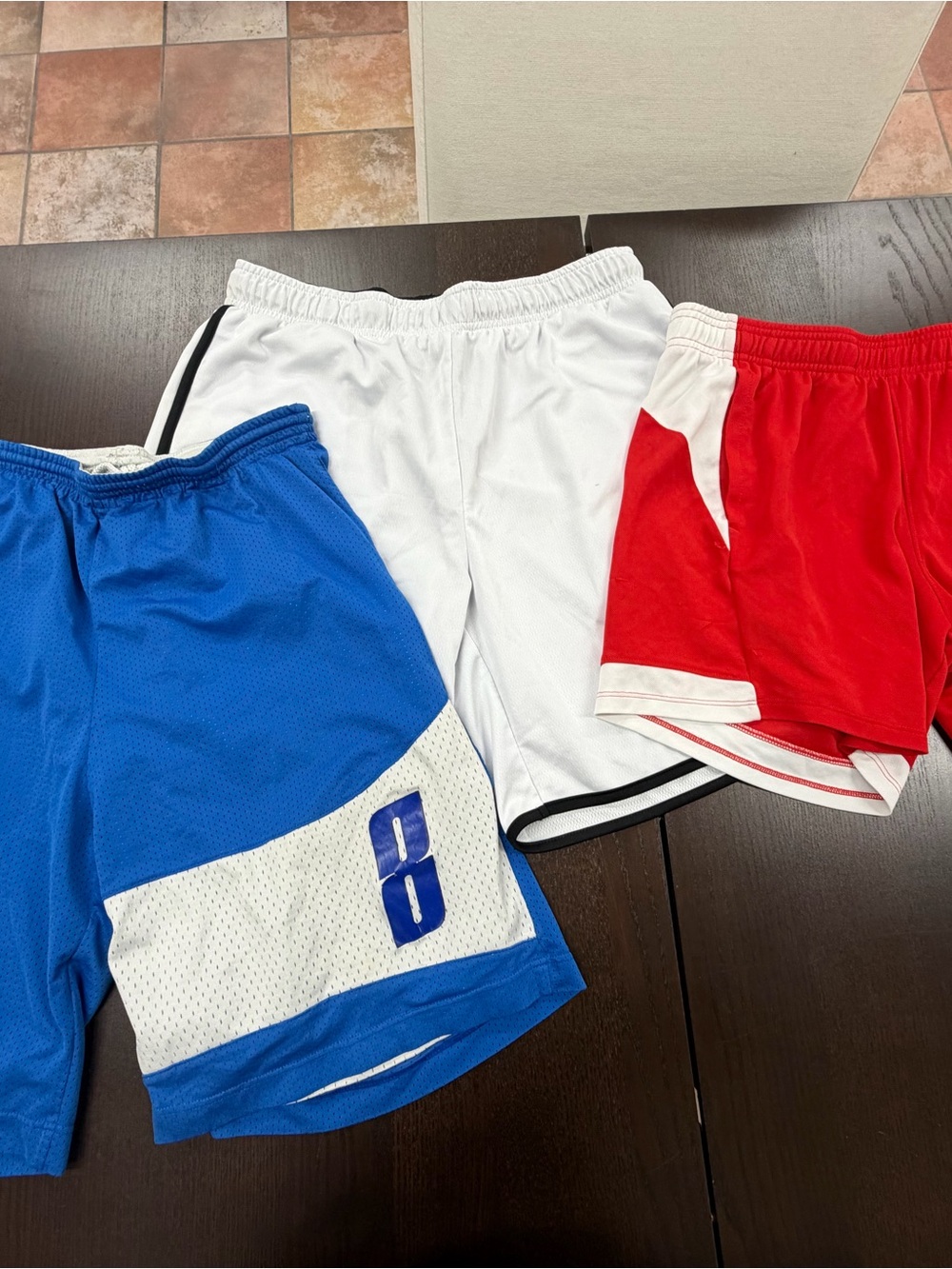 Three pairs of size medium basketball shorts